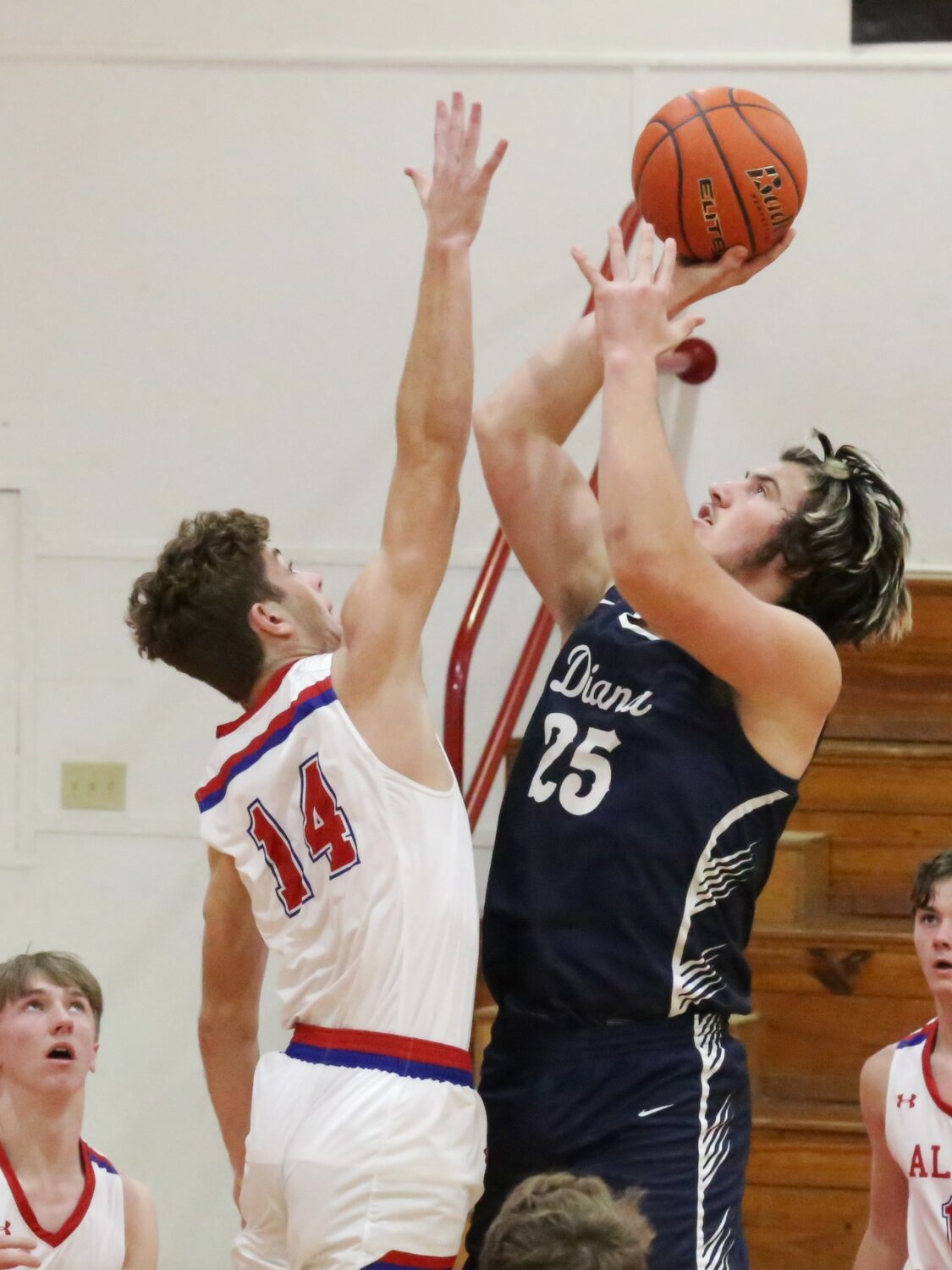 Wyatt Sutton challenges a shot from the New Diana low post in action last Friday.